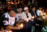 Hundreds of racing fans gather for a candlelight vigil on Monday, Feb. 19, 2001 in front of the Daytona International Speedway in Daytona Beach, Fla. to honor the memory of NASCAR driver Dale Earnhardt.